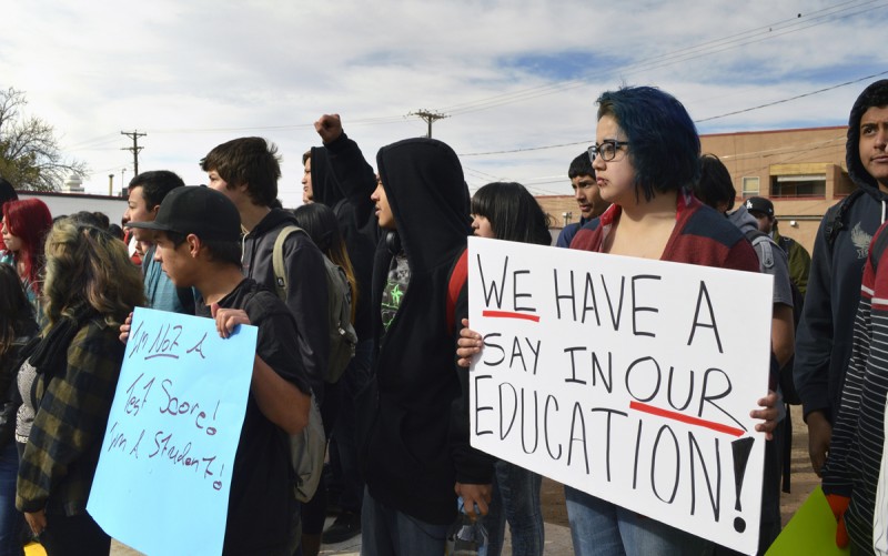 Dolores Ramos, 16, right, joins dozens of Highland High School students in Albuquerque, N.M., as students staged a walkout Monday March 2, 2015, to protest a new standardized test they say isn't an accurate measurement of their education. Students frustrated over the new exam walked out of schools across the state Monday in protest as the new exam was being given. The backlash came as millions of U.S. students start taking more rigorous exams aligned with Common Core standards.