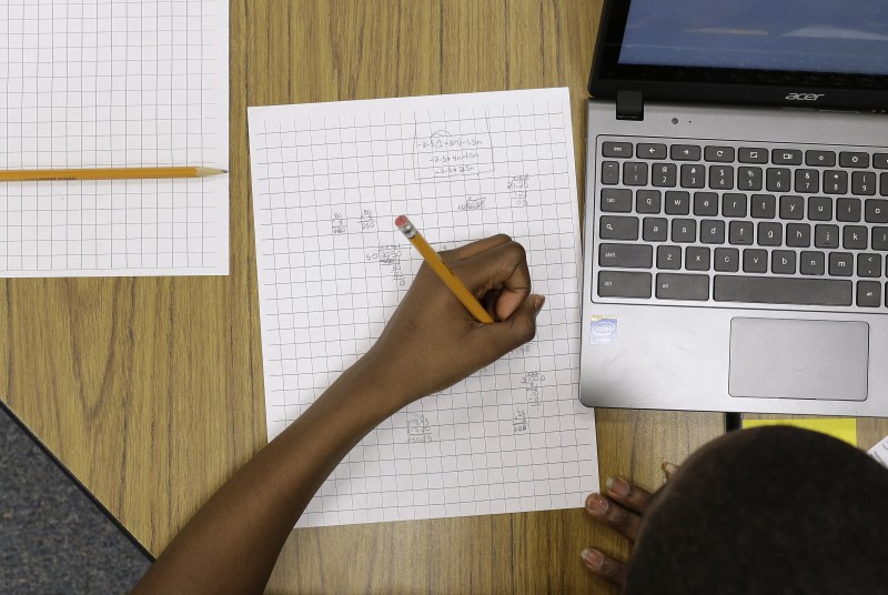 In this Feb. 12, 2015 photo, Yamarko Brown, age 12, works on math problems as part of a trial run of a new state assessment test at Annapolis Middle School in Annapolis, Md. The new test, which is scheduled to go into use March 2, 2015, is linked to the Common Core standards, which Maryland adopted in 2010 under the federal No Child Left Behind law, and serves as criteria for students in math and reading.