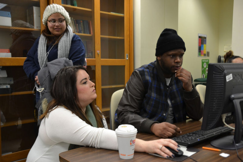 Laquon Jackson receives help from his Introduction to the Health Care Professions instructor, Elizabeth Dalianis.
