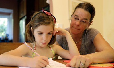 Stacey Jacobson-Francis works on math homework with her 6 year old daughter Luci Wednesday, May 14, 2014, at their home in Berkeley, Calif. As schools around the U.S. implement national Common Core learning standards, parents trying to help their kids with math homework say that adding, subtracting, multiplying and dividing has become as complicated as calculus. Stacey Jacobson-Francis, 41, of Berkeley, California, said her daughter’s homework requires her to know four different ways to add. “That is way too much to ask of a first grader. She can’t remember them all, and I don’t know them all, so we just do the best that we can,” she said. (AP Photo)