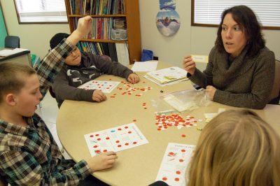 Braeburn teacher Shannon Mlodzinski with three of her fifth-graders. (Photo by Sarah Butrymowicz)