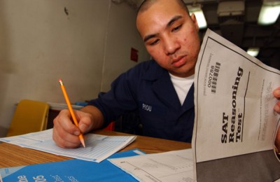 Chanthorn Peou of San Diego, Calif., takes the SAT aboard the USS Kitty Hawk (U.S. Navy photo by Jason T. Poplin)