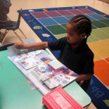 A Lighthouse Academy kindergartener participates in silent reading time. (Photo by Sarah Butrymowicz)