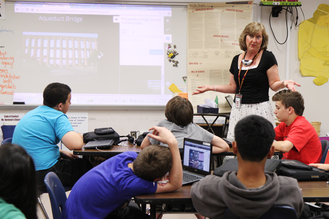 Seventh-grade social studies teacher Jennifer Harmsen reviews lessons in an online video on Roman life with her students at Hillsborough Middle School. (Photo: Meghan E. Murphy)