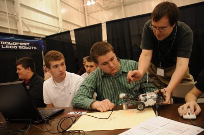 Engineer Matthew Skalny helps a student program a robot at the Robofest Lego Robotics station during Robotics Engineering and Technology (RET) Week, held May 4–5, 2010, at Macomb Community College, Warren, MI. More than 2,000 students from Michigan junior and senior high schools attended RET week, which provided them with a hands-on look at robotics careers and the crucial role robotic platforms play for the U.S. Army. (U.S. Army TARDEC photo by Elizabeth Carnegie.)