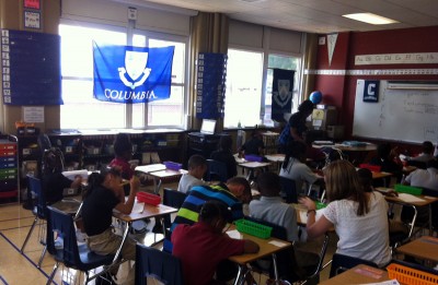 The classrooms at Cornerstone Prep, a young charter school in Memphis' Achievement School District, are named after colleges and universities like Columbia. College banners and flags hang throughout the school. (Photo: Sarah Carr)