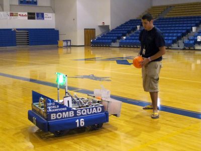 A student from Mountain Home's robotics team, demonstrates the club's award winning creation.
