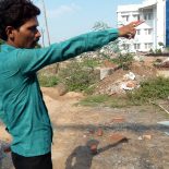 Ravi Sarma, an assistant professor of property law, points out new buildings going up at Chanakya National Law University, one of several new higher education institutions in Bihar, India's poorest state. (Photo by Sarah Garland)