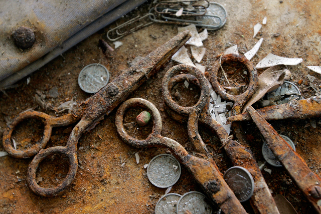 Rusted scissors, coins and other debris sit on the floor of an elementary school in the Lakeview neighborhood of New Orleans, La. File Photo.  (AP Photo/Eric Gay)