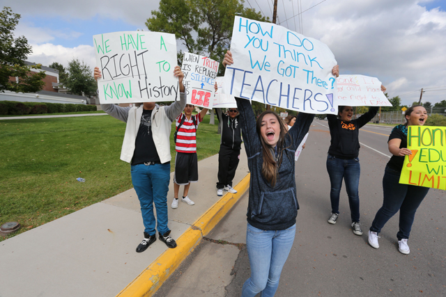 Students protest against a Jefferson County School Board proposal to emphasize patriotism and downplay civil unrest in the teaching of U.S. history, in front of their school, Jefferson High, in the Denver suburb of Edgewater, Monday, Sept. 29, 2014. (AP Photo/Brennan Linsley)